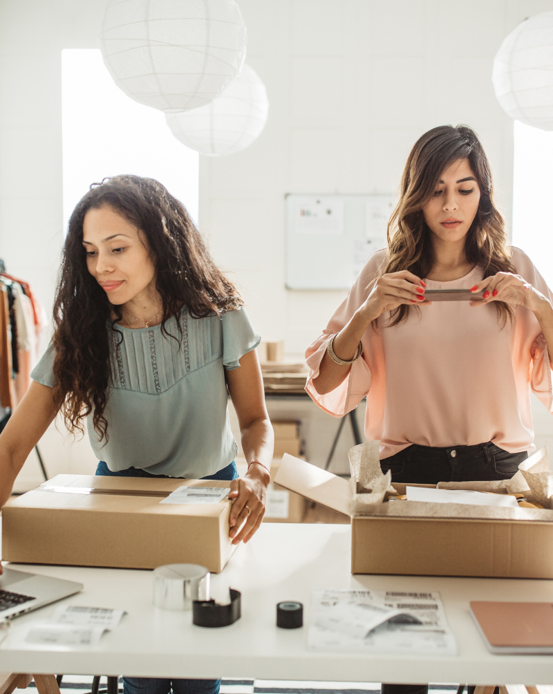 Two women work packaging items for their small business